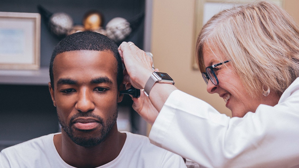 Doctor checking ears for hearing loss