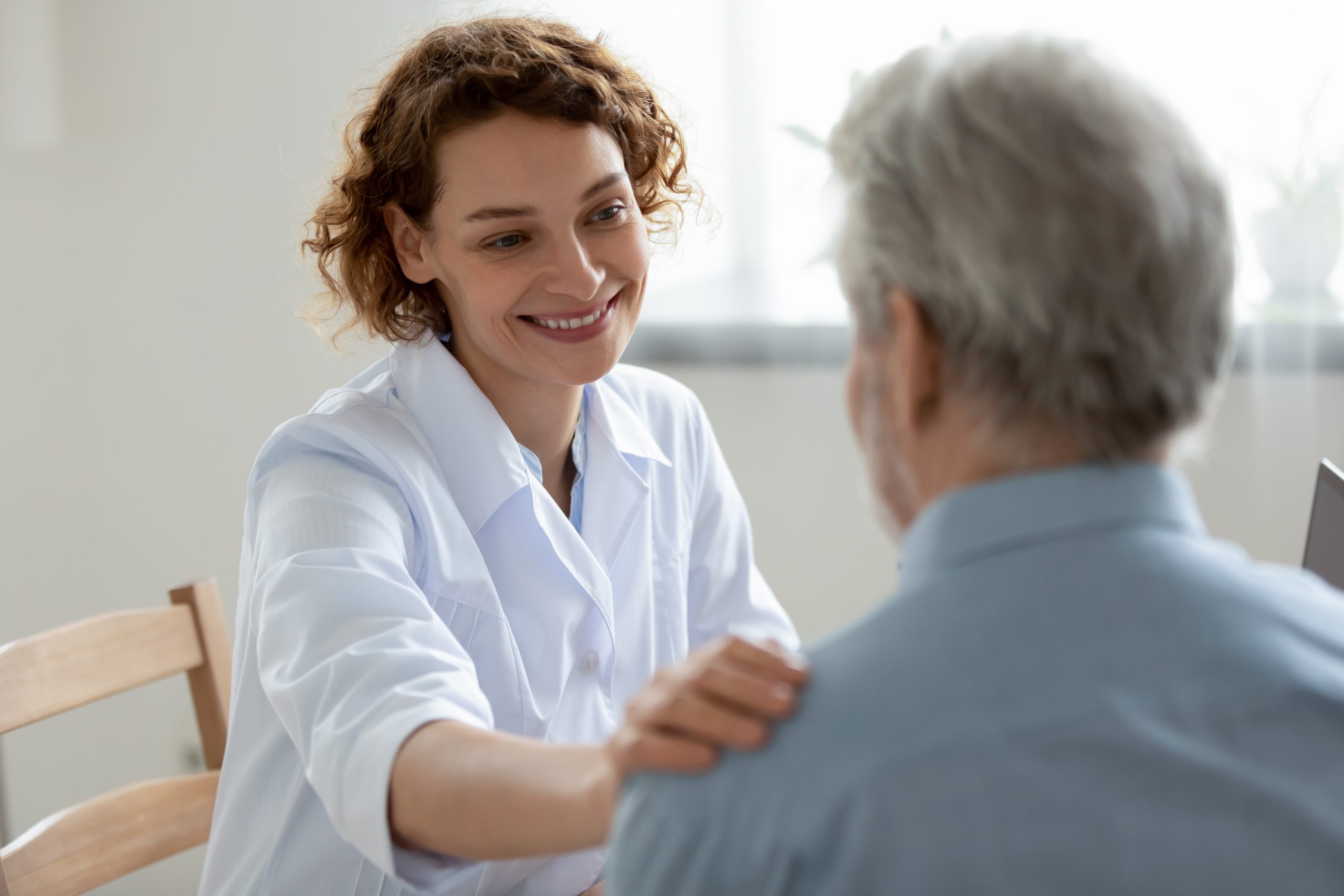 Caring Audiologist with patient